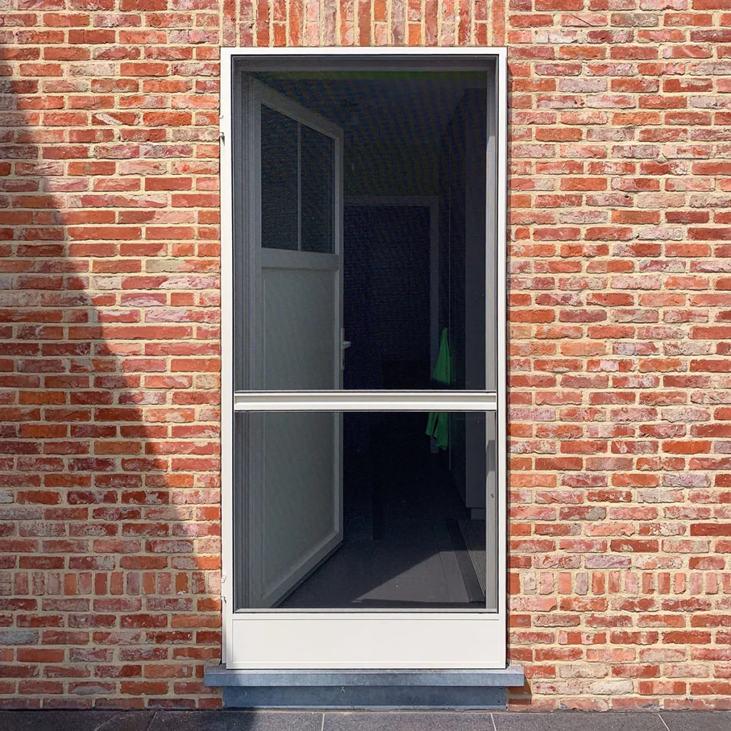 Brick exterior with a tall glass doorwindow set in a white frame interior dark hallway visible through the glass Insectenwering   RDT concept